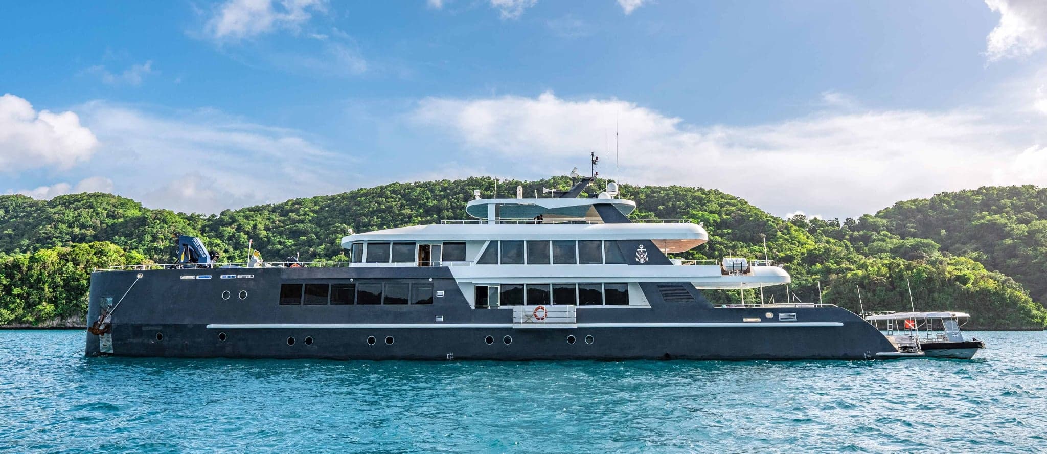 Black Pearl, a 46-meter luxury yacht, cruises Palau's pristine waters, offering divers access to sites like Blue Corner and German Channel, renowned for abundant marine life including sharks and manta rays