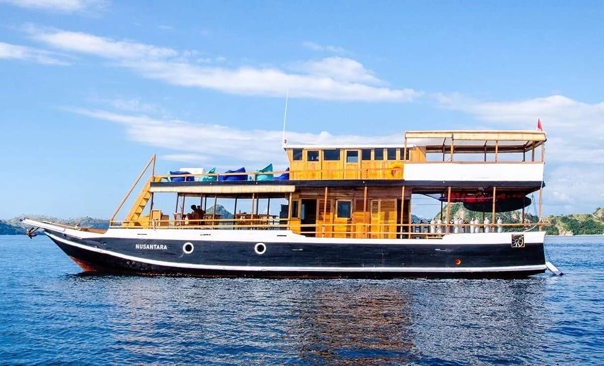 The Nusantara liveaboard cruises Komodo National Park, diving Crystal Rock and The Cauldron, where nutrient-rich waters attract manta rays, reef sharks, and swirling fish schools