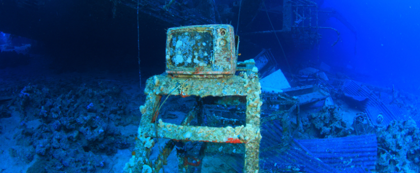 Salem Express A coral-covered television set sitting on a stand inside the wreck of the Salem Express.