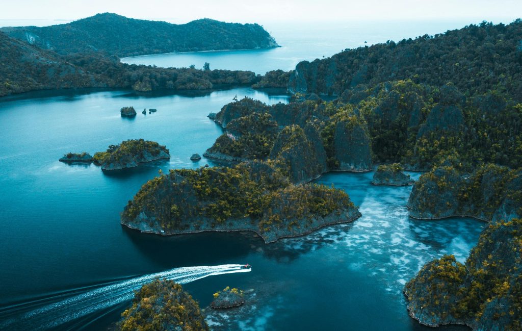 Aerial view of Raja Ampat’s limestone islands and blue waters, a top liveaboard diving destination in Indonesia, known for vibrant coral reefs, diverse marine life, and world-class scuba diving adventures