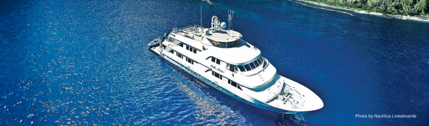 High-angle view of the luxurious 147-foot Nautilus Belle Amie liveaboard featuring four decks for Socorro diving expeditions. 