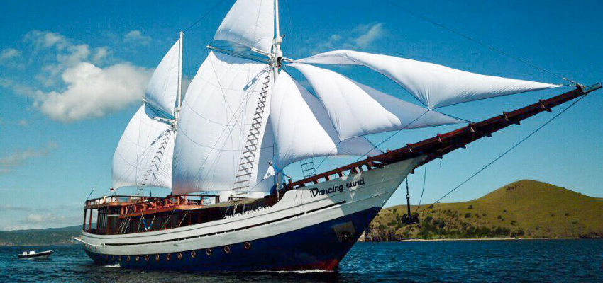 Dancing Wind Liveaboard Indonesia Intimate luxury dive yacht Dancing Wind navigating the calm turquoise waters of Raja Ampat.