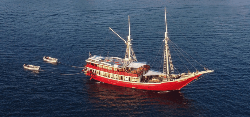 Seven Seas Liveaboard Indonesia Classic custom-built teak and ironwood liveaboard Seven Seas navigating a remote open-ocean passage.