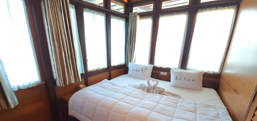 cabin Dancing Wind Liveaboard Indonesia Beautifully styled, spacious luxury cabin interior with premium linens and wood paneling on the Dancing Wind liveaboard.