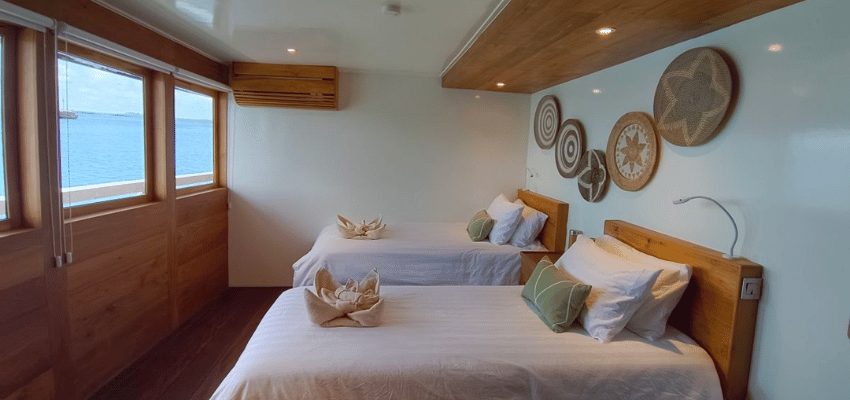 cabin Emperor Harmoni Liveaboard Indonesia Refined and spacious master stateroom on Emperor Harmoni liveaboard with traditional wood finish.