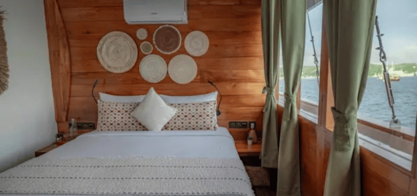 cabin Fenides Liveaboard Indonesia Ultra-modern minimalist cabin design on Fenides featuring bright woodwork and built-in media entertainment centers.