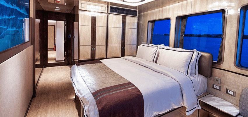 cabin Velocean Liveaboard Indonesia Platinum Oceanfront Suite on Velocean showcasing floor-to-ceiling panoramic windows and modern work desk.