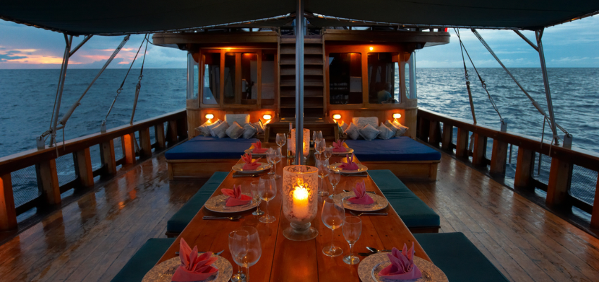 dining Tiger Blue Liveaboard Indonesia Wide main deck of Tiger Blue featuring water sports equipment, wakeboards, and comfortable outdoor seating.