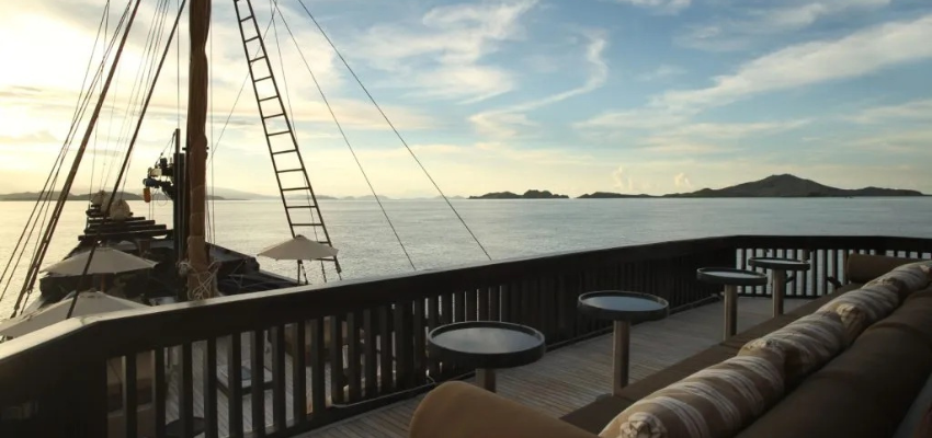 sundeck Alila Purnama Liveaboard Indonesia Expansive wooden sun deck of Alila Purnama outfitted with plush daybeds and panoramic views of the Komodo archipelago.