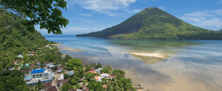 Topside view of the lush Gunung Api volcano rising from the ocean in the Banda Islands, Maluku, Indonesia