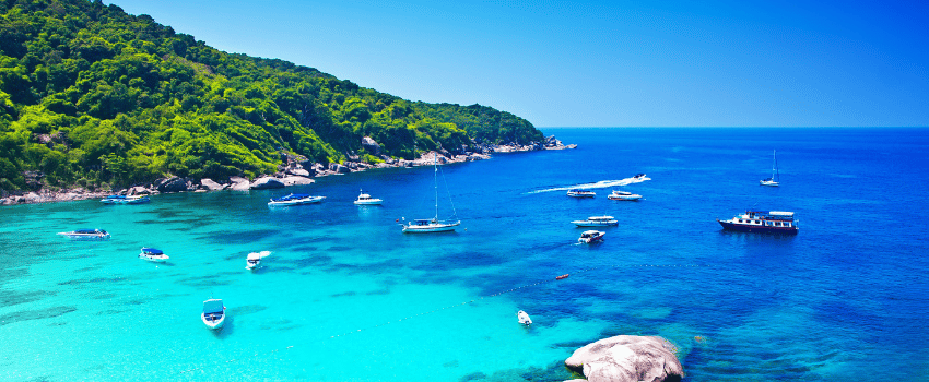 Dive boats in clear water near the Similan Islands, Thailand.