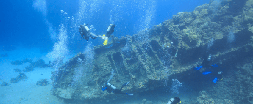 Scuba divers exploring a Red Sea wreck in Egypt.