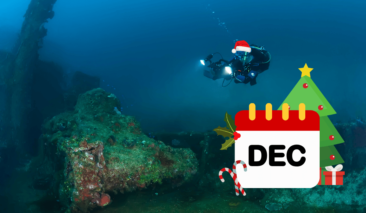 Scuba diver exploring a World War II wreck in Truk Lagoon, one of the best December dive destinations.