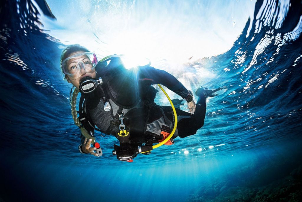 Female scuba diver exploring a reef