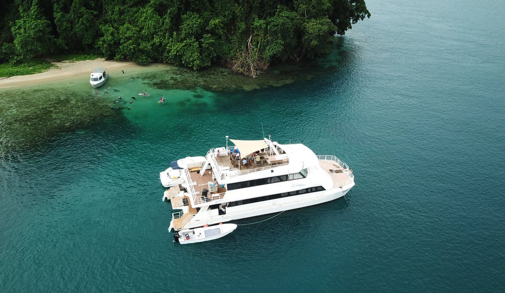 Oceania, a 27-meter catamaran, operates from Walindi Plantation Resort, exploring Papua New Guinea's Kimbe Bay, Witu Islands, and Fathers Reefs, areas known for vibrant coral reefs and diverse marine life