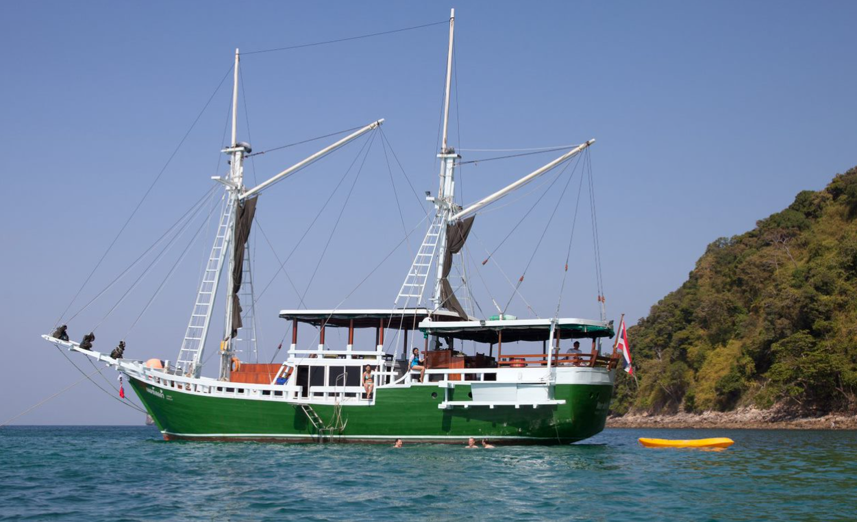 The Merdeka 1 yacht blends diving with comfort, stopping at Similan sites like Elephant Head Rock and Koh Bon, where leopard sharks and reef mantas cruise the clear waters