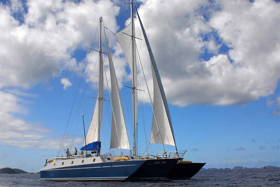 Cuan Law is a unique trimaran with sails and serious space. Its BVI itineraries combine easy, scenic dives with snorkeling, kayaking, and island exploration