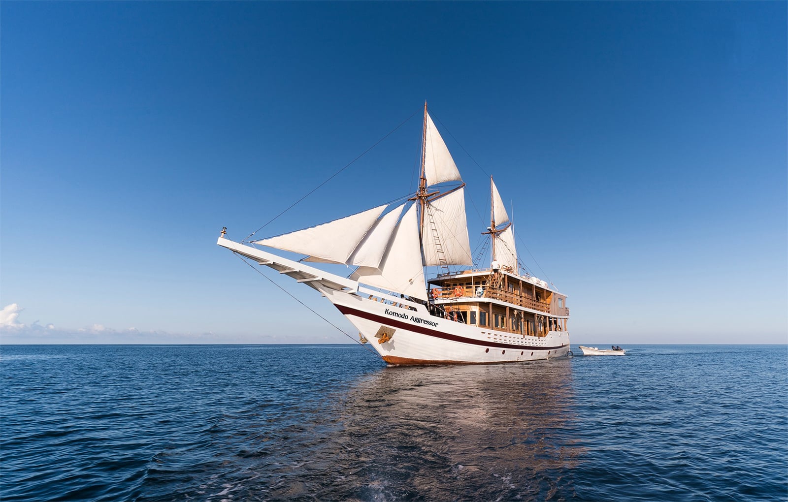 The Komodo Aggressor liveaboard offers diving in Komodo National Park, with sites like Batu Bolong and Castle Rock known for manta rays, reef sharks, and rich coral reefs