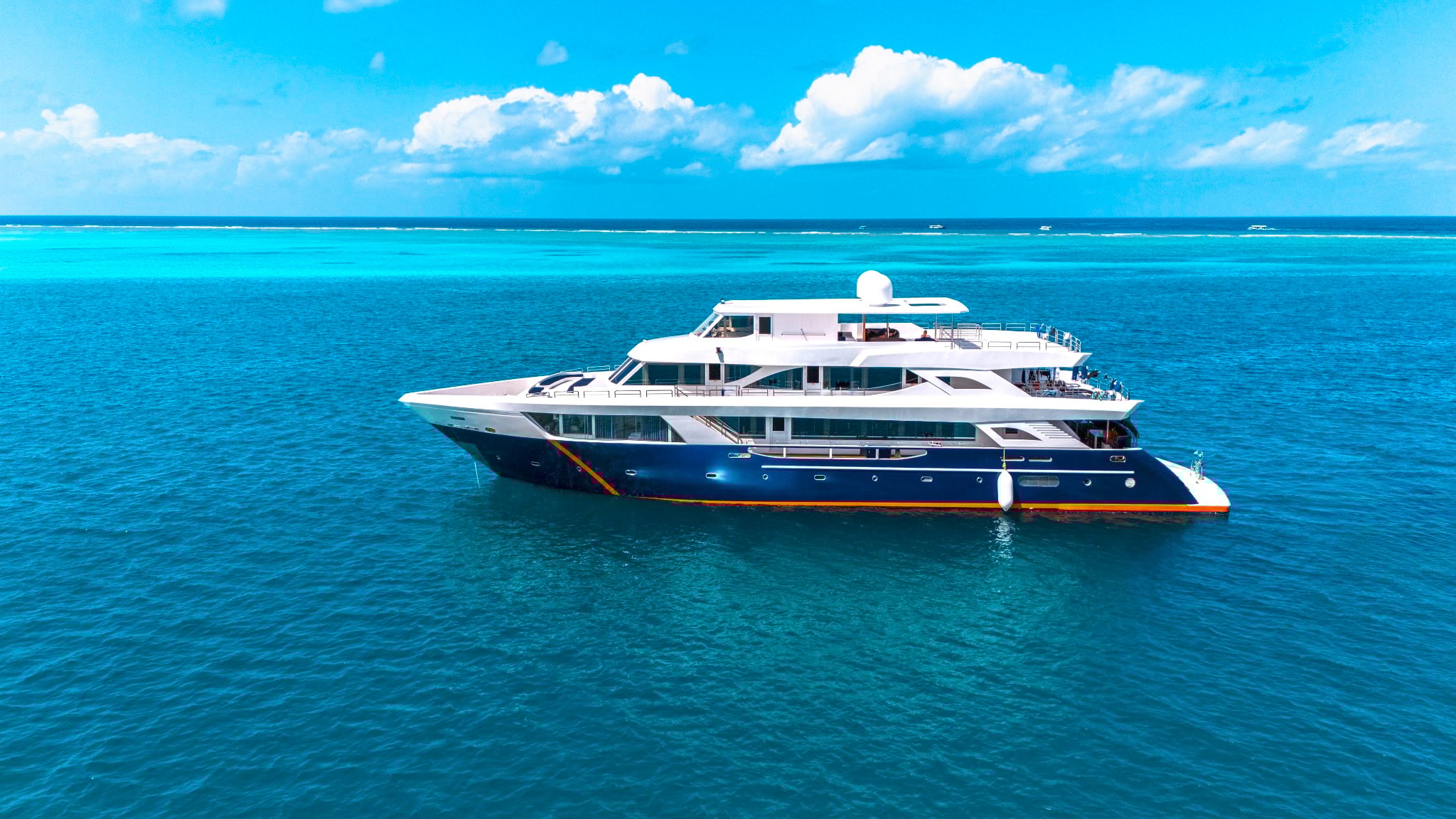 The Black Manta yacht travels through the central atolls of the Maldives, visiting sites like Fish Head and Kandooma Thila, home to grey reef sharks, eagle rays, and schools of snapper