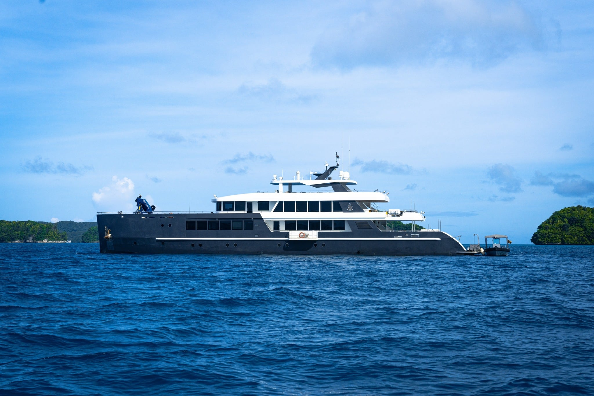 Black Pearl, a 46-meter luxury yacht, cruises Palau's pristine waters, offering divers access to sites like Blue Corner and German Channel, renowned for abundant marine life including sharks and manta rays