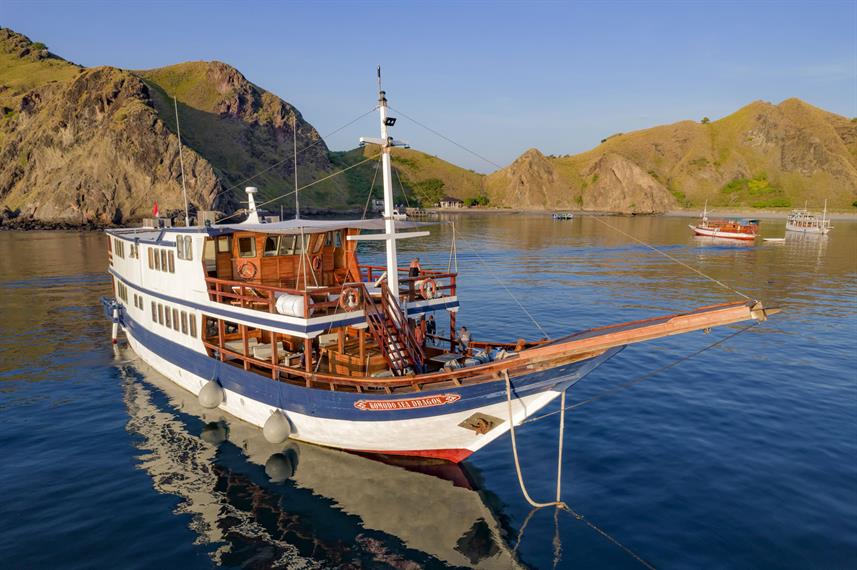 Komodo Sea Dragon is a traditional phinisi liveaboard offering elegant cabins with private balconies, small dive groups, and exceptional diving in Komodo National Park
