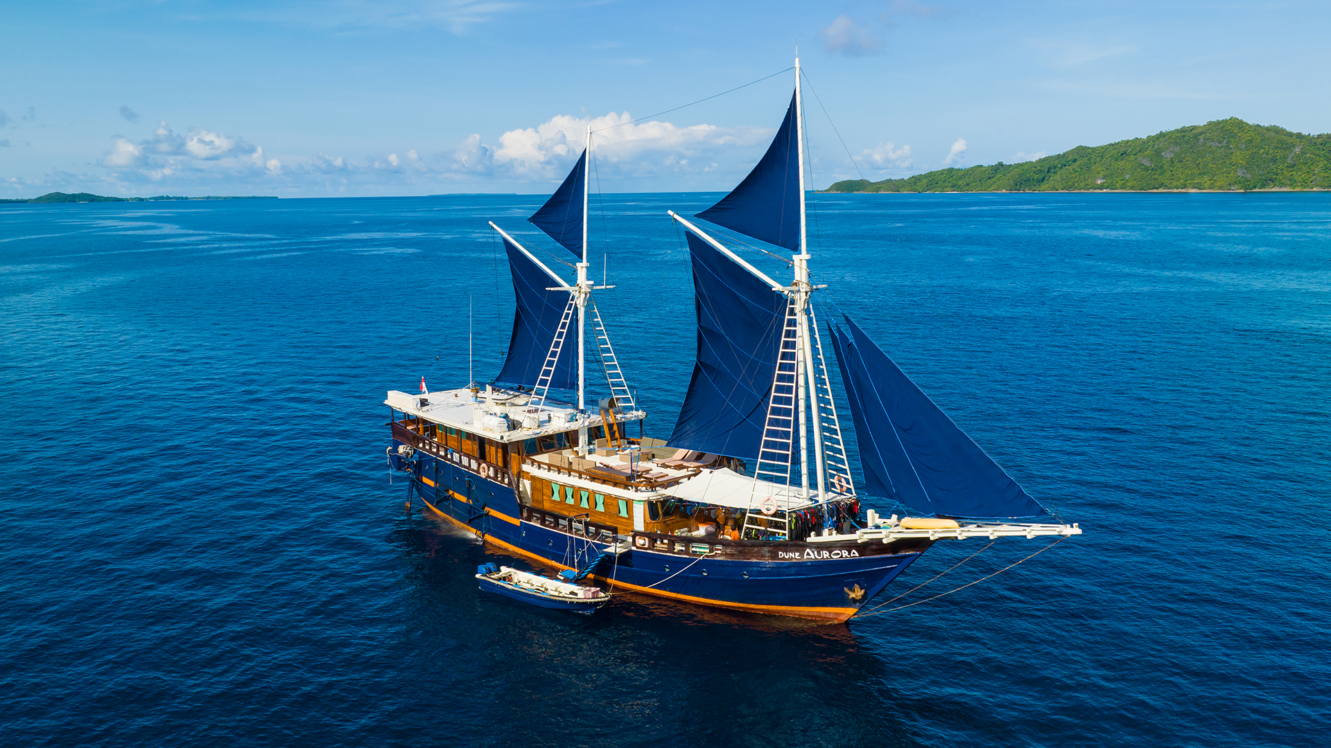 Aurora, a traditional phinisi, offers diving adventures in Indonesia's hotspots such as Komodo and Raja Ampat, known for encounters with manta rays, sharks, and vibrant coral gardens